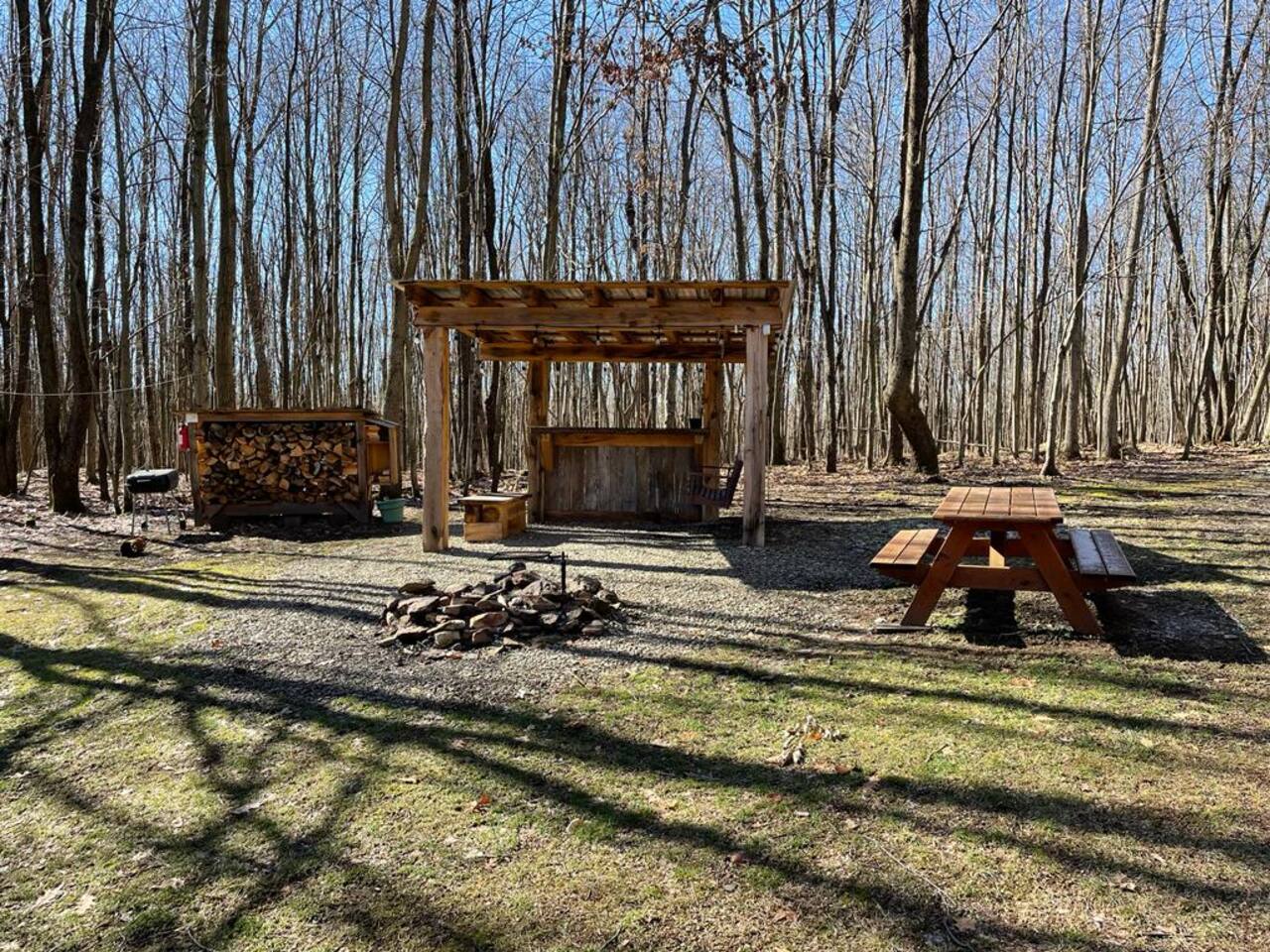 Outdoor pavilion and fire pit area at Hogback Lodge